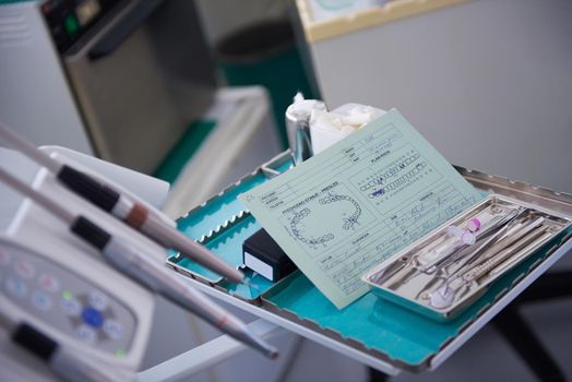 Closeup of a woman patient at the dentist waiting to be checked up with the woman doctor in the background