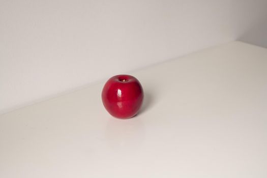 Red artificial apple on a white background