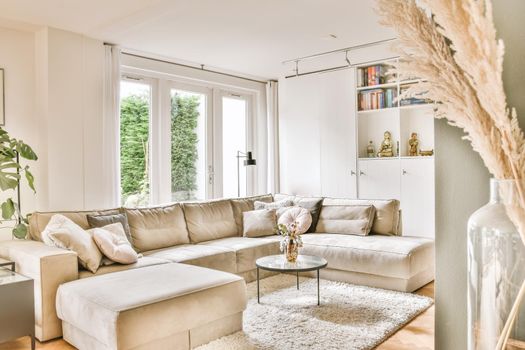 Living room with a large brown sofa and a small round coffee table