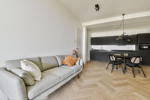 Gray comfortable and soft sofa with pillows in the living area