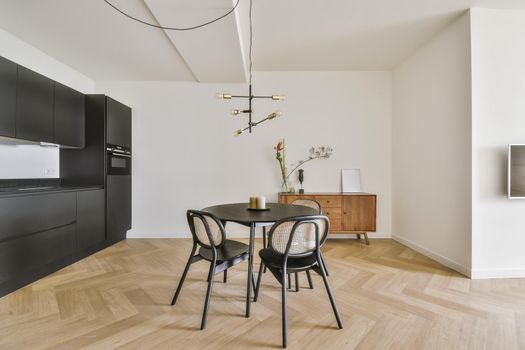 Mini dining area with small black table and chairs