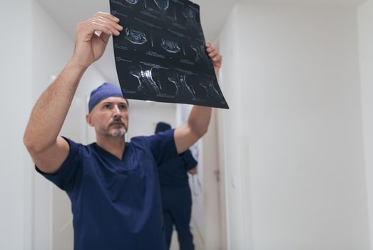 Orthopedist doctor examining X-ray picture at in hospital or clinic. High quality photo. Selective focus