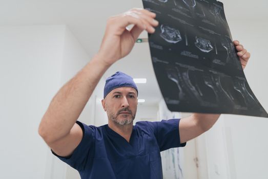 Orthopedist doctor examining X-ray picture at in hospital or clinic. High quality photo. Selective focus