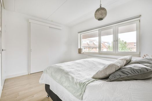 Stylish interior of contemporary bedroom with comfortable furniture