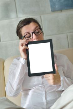 Young woman at home relaxing in her lliving room reading a digital tablet PC surf internet and work