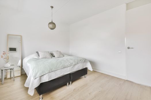 Stylish interior of contemporary bedroom with comfortable furniture