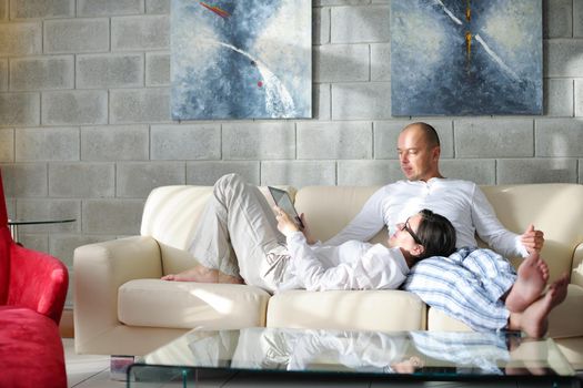 happy young  Couple Using Digital Tablet computer At Home