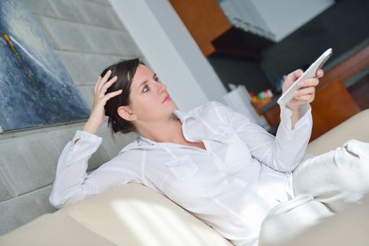 happy young woman watching tv at modern home livingroom