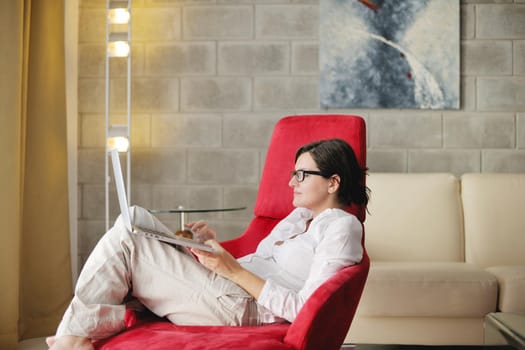 woman working on laptop computer and relax at modern home