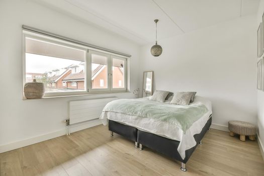 Stylish interior of contemporary bedroom with comfortable furniture