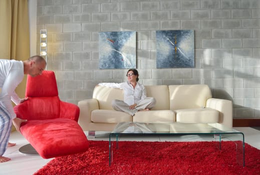 happy young woman relax at home on sofa in bright living room and watching tv