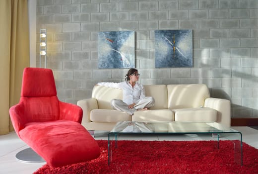 happy young woman relax at home on sofa in bright living room and watching tv