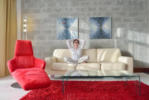 happy young woman relax at home on sofa in bright living room and watching tv