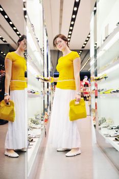 happy young woman shopping in big modern city mall