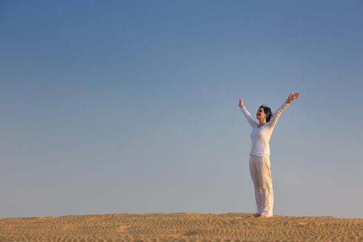 happy young woman relax and exercise yoga at desert in sunset