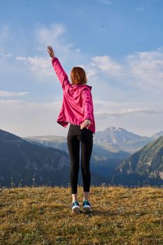 woman hiker outdoors in the mountains landscape fresh air. High quality photo
