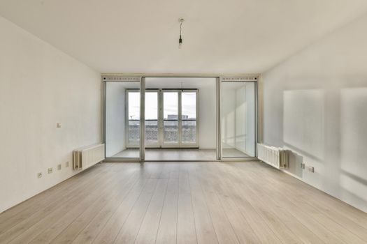 A bright room with large windows on the entire wall