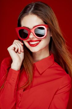 cheerful woman in a red shirt sunglasses Glamor close-up. High quality photo