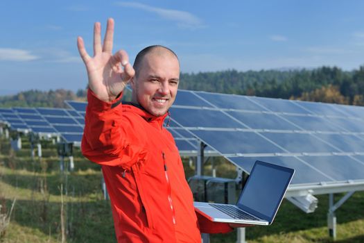 business man  engineer using laptop at solar panels plant eco energy field  in background