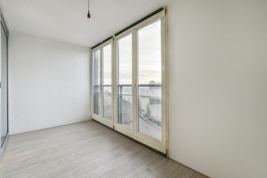 A bright room with large windows on the entire wall