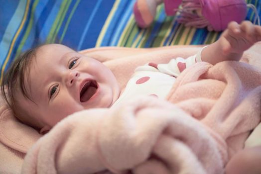 cute little baby playing with hand and smiling with  no teeth funny smile