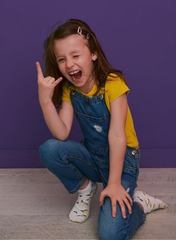 cute children portrait. Little girl smiling at home making funny face and acting