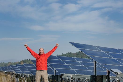 business man  engineer using laptop at solar panels plant eco energy field  in background