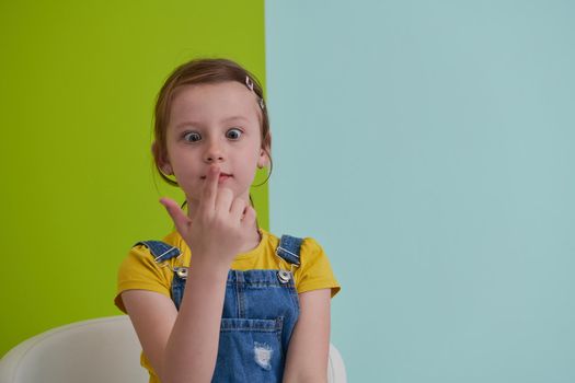 cute children portrait. Little girl smiling at home making funny face and acting