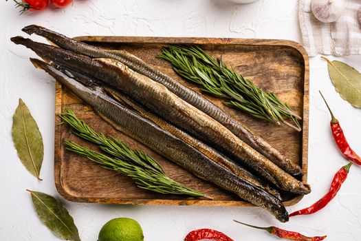 Smoked lamprey set, on white stone table background, top view flat lay