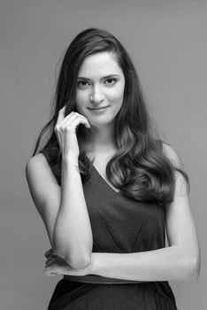 beautiful young brunette woman in a gray dress posing and expresses different emotions. close-up portret