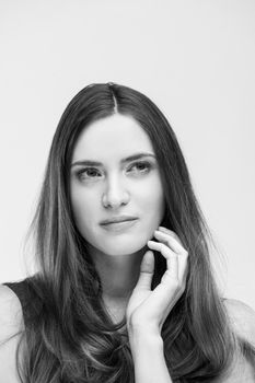 beautiful young brunette woman in a gray dress posing and expresses different emotions. close-up portret