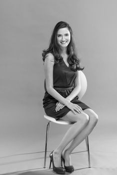 beautiful young brunette woman in a gray dress posing and expresses different emotions. close-up portret