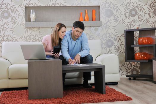 young couple at home with  modern livingroom indoor working on laptop on house finance and planing