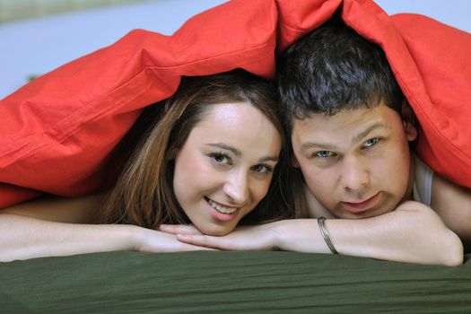 happy young couple in bed at morning