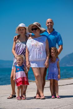 Portrait of happy multi generation family holding their hands while standing on the beach coast during Summer vacation Healthy family lifestyle concept