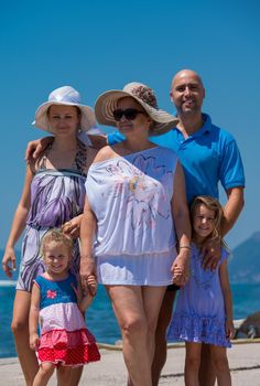 Portrait of happy multi generation family holding their hands while standing on the beach coast during Summer vacation Healthy family lifestyle concept