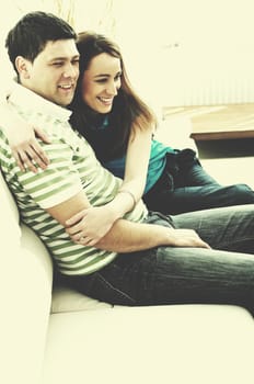 happy young couple relax at home in modern and bright living room 