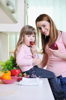 happy young family have lunch time with fresh fruits and vegetable food in bright kitchen