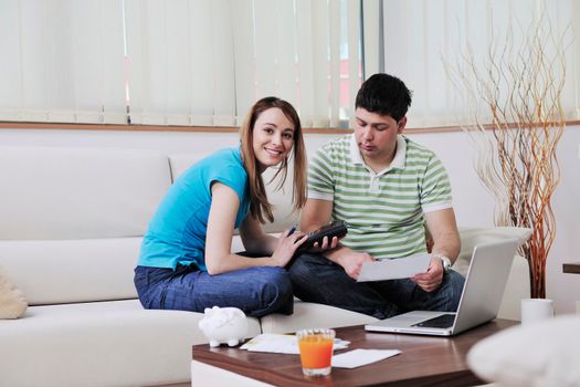 young couple at home with  modern livingroom indoor working on laptop on house finance and planing