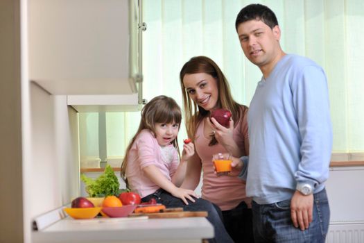 happy young family have lunch time with fresh fruits and vegetable food in bright kitchen