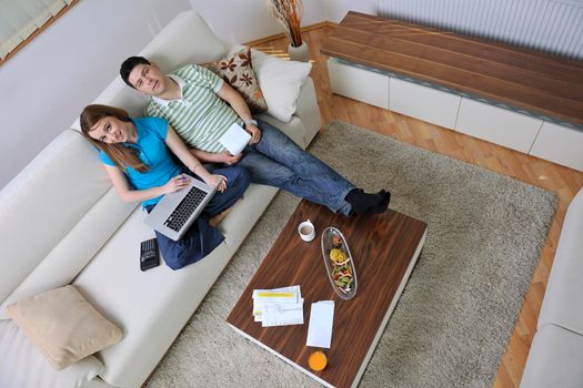 young couple at home with  modern livingroom indoor working on laptop on house finance and planing