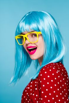 glamorous woman in blue wig yellow glasses posing model. High quality photo