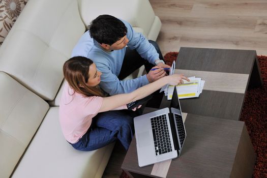 young couple at home with  modern livingroom indoor working on laptop on house finance and planing