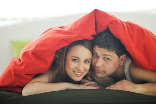 happy young couple in bed at morning