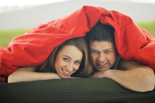 happy young couple in bed at morning