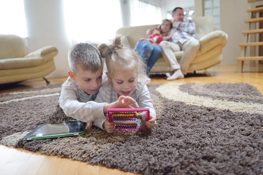 hapy young family have fun  with their children at modern living room home indoors