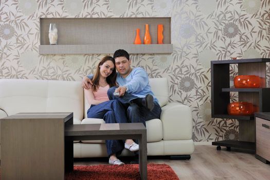 happy young couple relax at home in modern and bright living room