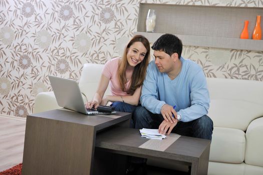 young couple at home with  modern livingroom indoor working on laptop on house finance and planing