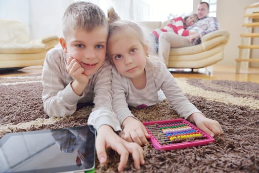 hapy young family have fun  with their children at modern living room home indoors