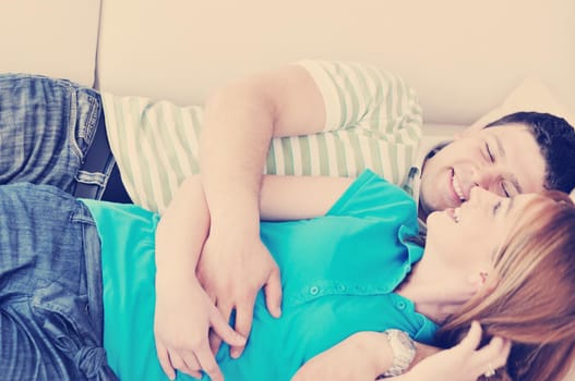 happy young couple relax at home in modern and bright living room